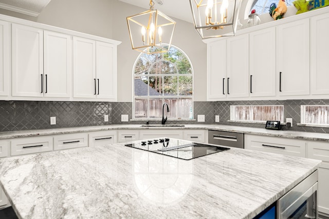 14102 Haynes Dr, Houston, TX 77069 - kitchen featuring an inviting chandelier, tasteful backsplash, white cabinets, a center island, and a sink