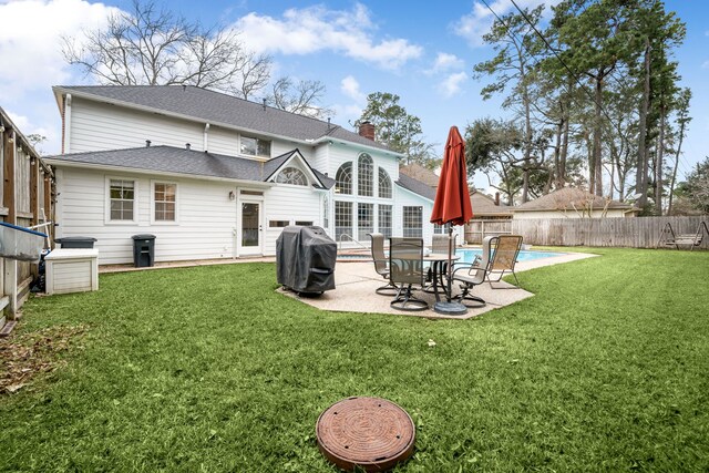 14102 Haynes Dr, Houston, TX 77069 - back of house with a yard, a patio area, a chimney, a fenced backyard, and a fenced in pool