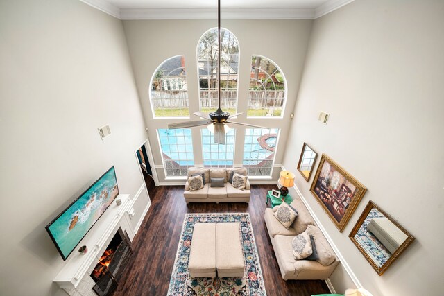 14102 Haynes Dr, Houston, TX 77069 - living room with a warm lit fireplace, wood finished floors, plenty of natural light, and a towering ceiling