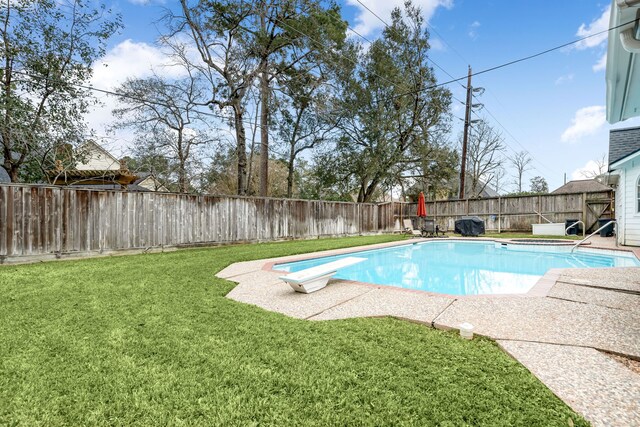 14102 Haynes Dr, Houston, TX 77069 - view of pool with a fenced backyard, a diving board, a fenced in pool, and a lawn