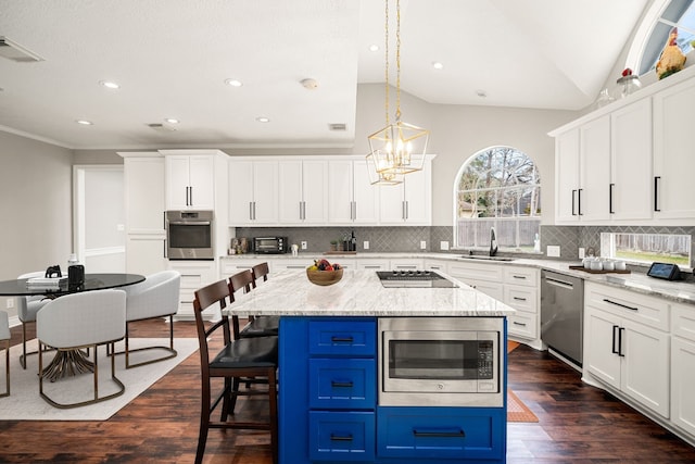 14102 Haynes Dr, Houston, TX 77069 - kitchen featuring tasteful backsplash, white cabinets, blue cabinetry, and stainless steel appliances