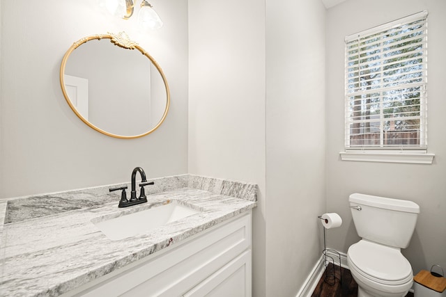 14102 Haynes Dr, Houston, TX 77069 - half bath featuring toilet, baseboards, vanity, and wood finished floors