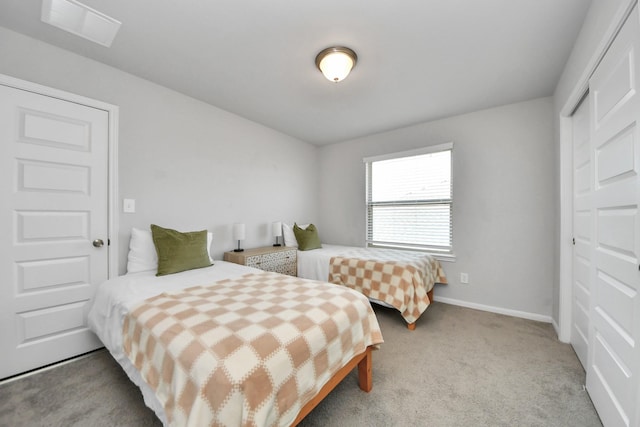carpeted bedroom featuring baseboards and visible vents