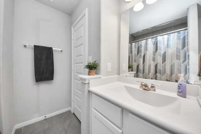 bathroom featuring baseboards, vanity, and a shower with curtain