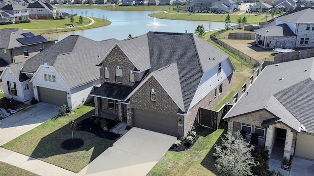 birds eye view of property with a water view and a residential view