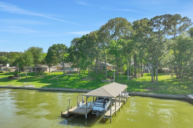 view of dock featuring a water view, a yard, and boat lift