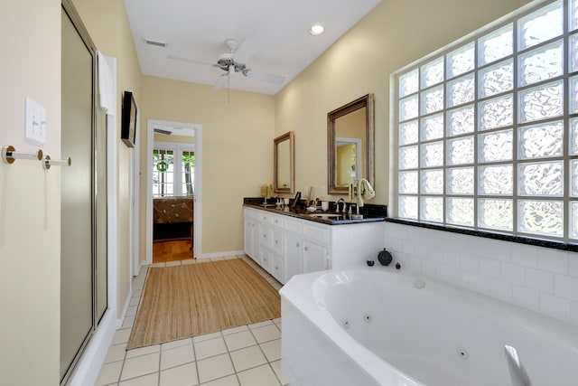 bathroom featuring a ceiling fan, visible vents, tile patterned floors, a jetted tub, and double vanity