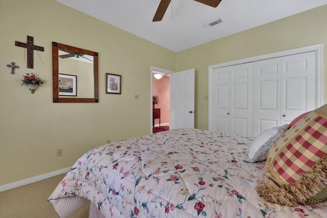 bedroom with a closet, baseboards, a ceiling fan, carpet floors, and visible vents