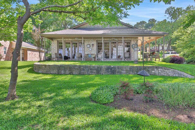 view of front facade with a front yard and stone siding