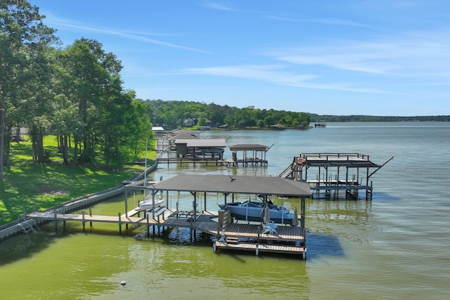 dock area featuring boat lift and a water view