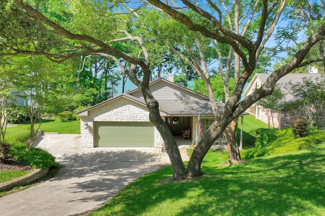 view of front of property featuring an attached garage, stone siding, a chimney, concrete driveway, and a front lawn