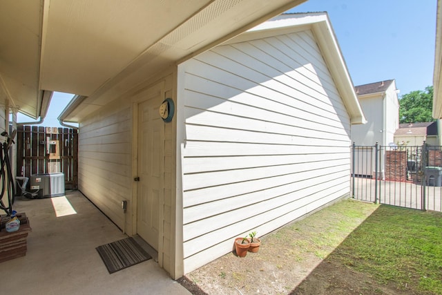 view of property exterior with a patio area and fence