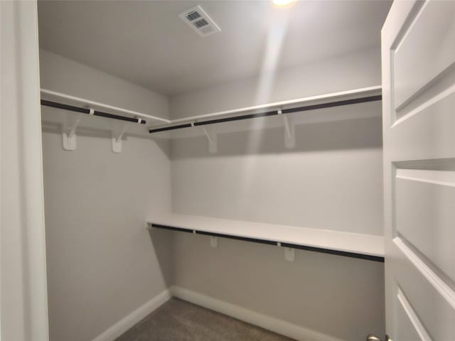 spacious closet with carpet and visible vents