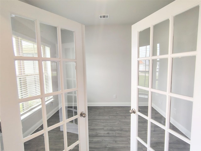 interior space featuring french doors, wood finished floors, baseboards, and visible vents