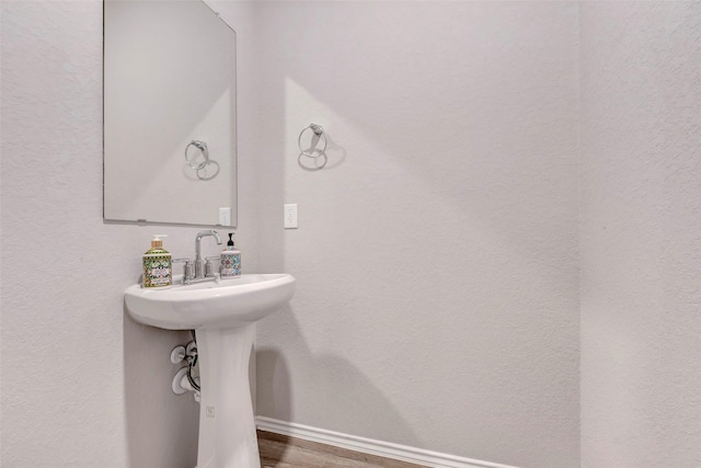 21723 Sarasota Spice St, Tomball, TX 77377 - bathroom featuring baseboards and wood finished floors