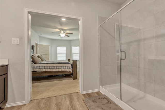 21723 Sarasota Spice St, Tomball, TX 77377 - full bath featuring baseboards, ceiling fan, ensuite bath, wood finished floors, and a stall shower