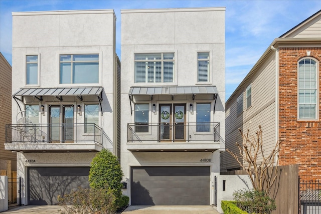 4410 Floyd St Unit B, Houston, TX 77007 - view of property with stucco siding, a standing seam roof, a balcony, and a garage