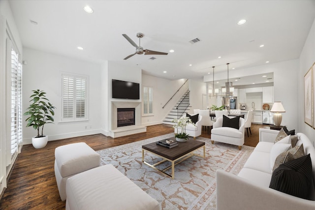 4410 Floyd St Unit B, Houston, TX 77007 - living area featuring stairs, wood finished floors, a glass covered fireplace, plenty of natural light, and recessed lighting