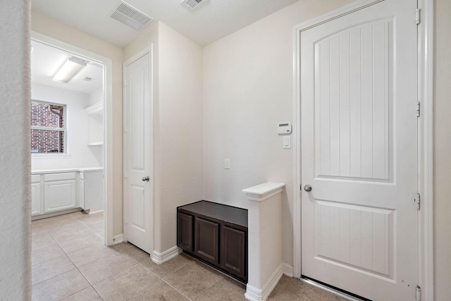 interior space featuring visible vents, baseboards, and light tile patterned flooring