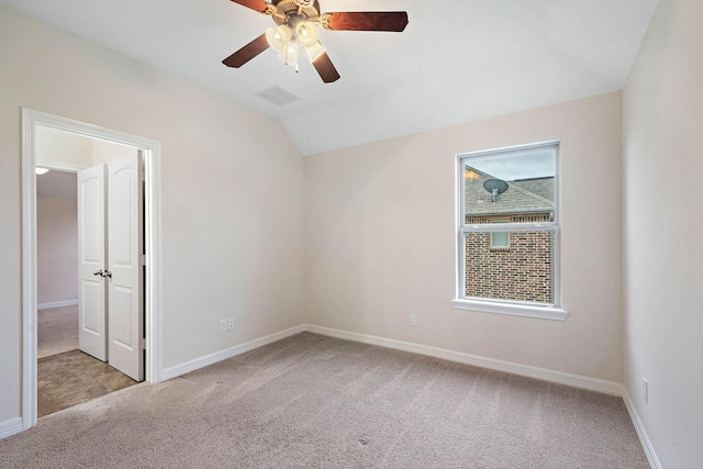 unfurnished room featuring carpet flooring, baseboards, vaulted ceiling, and ceiling fan