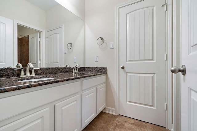 full bathroom featuring a sink, double vanity, and tile patterned flooring