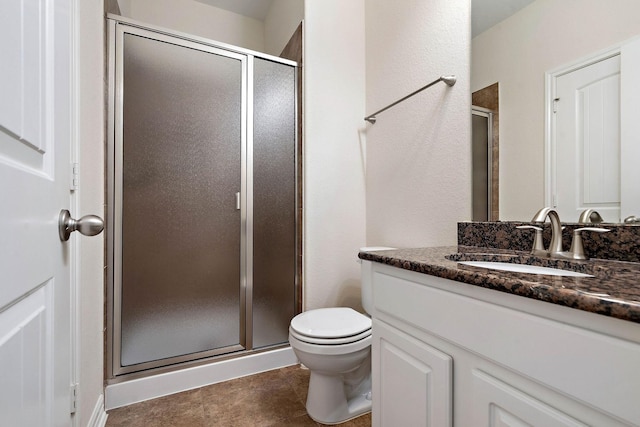 full bath with a shower stall, vanity, and toilet