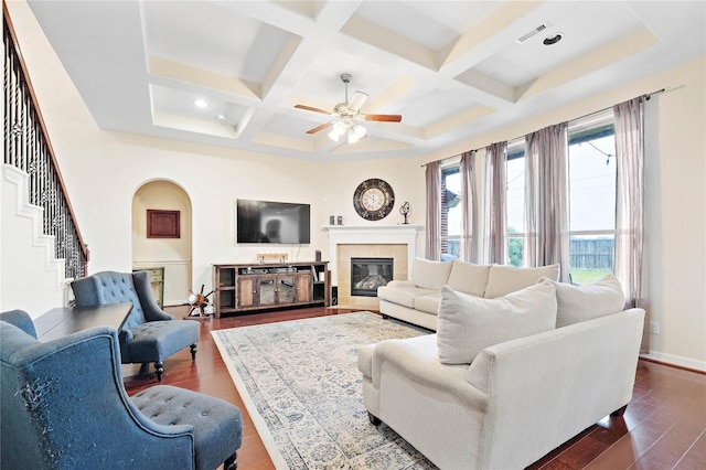 living room featuring visible vents, a ceiling fan, dark wood-style floors, coffered ceiling, and a glass covered fireplace
