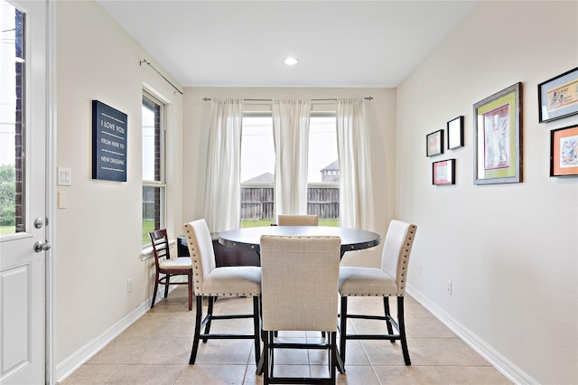 dining room featuring a wealth of natural light, recessed lighting, light tile patterned floors, and baseboards