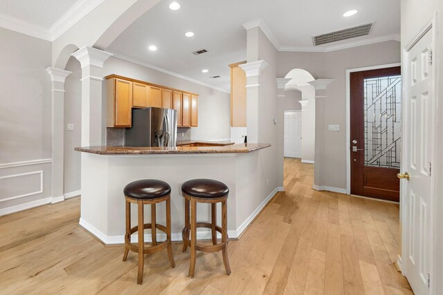 kitchen featuring light wood-type flooring, visible vents, and stainless steel refrigerator with ice dispenser