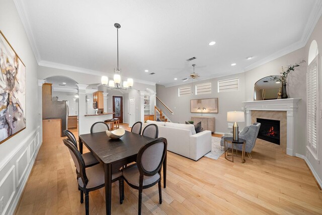 dining space with visible vents, ornamental molding, ceiling fan, and decorative columns