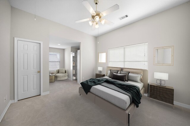 carpeted bedroom featuring baseboards, a ceiling fan, and visible vents