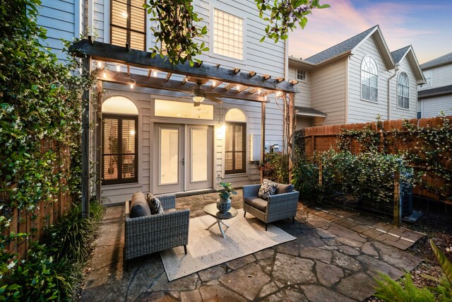 rear view of house featuring a pergola, outdoor lounge area, a patio, and fence