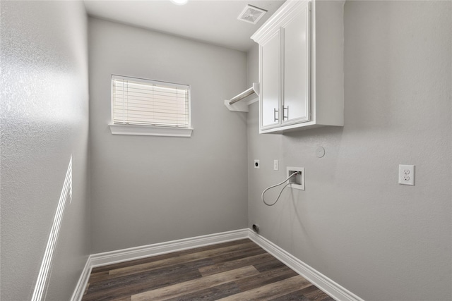 laundry room with dark wood-style flooring, electric dryer hookup, baseboards, visible vents, and cabinet space