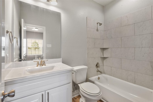 bathroom featuring toilet, vanity, and shower / bathing tub combination