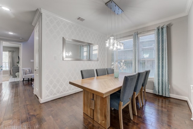 dining room featuring visible vents, baseboards, wallpapered walls, and crown molding