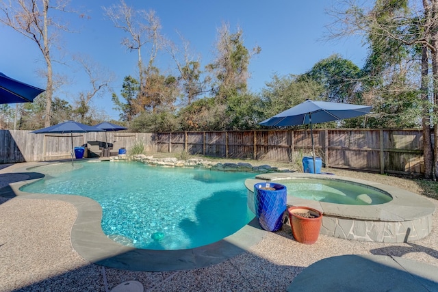 view of swimming pool featuring a patio area, a fenced backyard, an in ground hot tub, and a fenced in pool