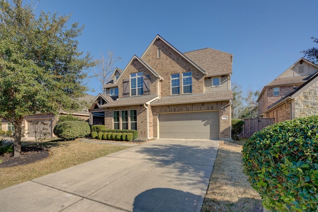 craftsman inspired home with brick siding, a shingled roof, a garage, and concrete driveway