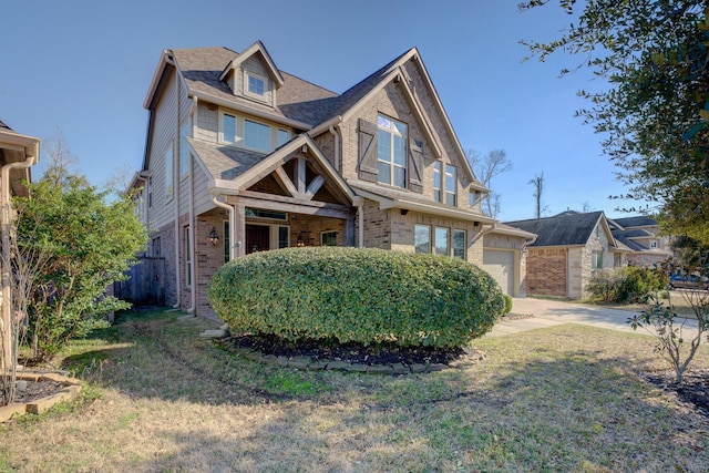 view of front of property featuring roof with shingles, a garage, driveway, and brick siding
