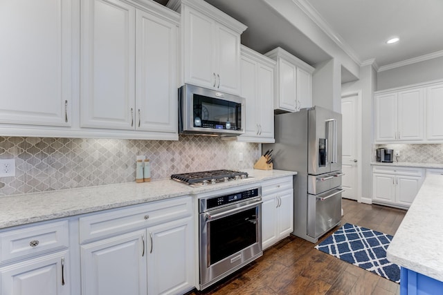 kitchen with stainless steel appliances, dark wood-style flooring, white cabinetry, and ornamental molding