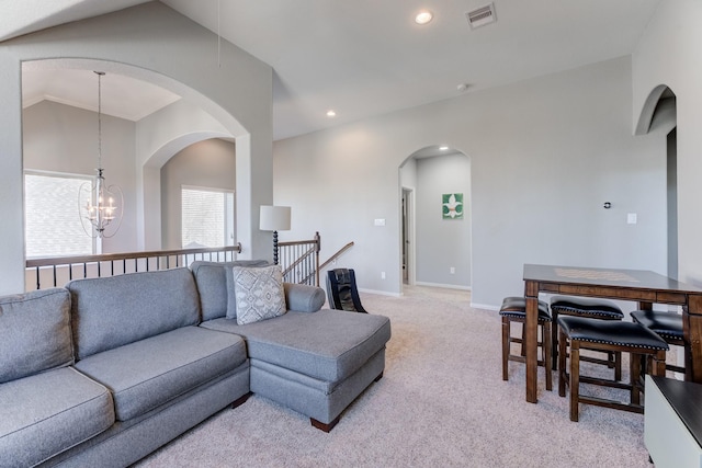 living room featuring an inviting chandelier, light carpet, recessed lighting, visible vents, and lofted ceiling