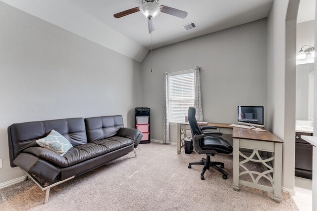 carpeted home office featuring ceiling fan, baseboards, vaulted ceiling, and visible vents