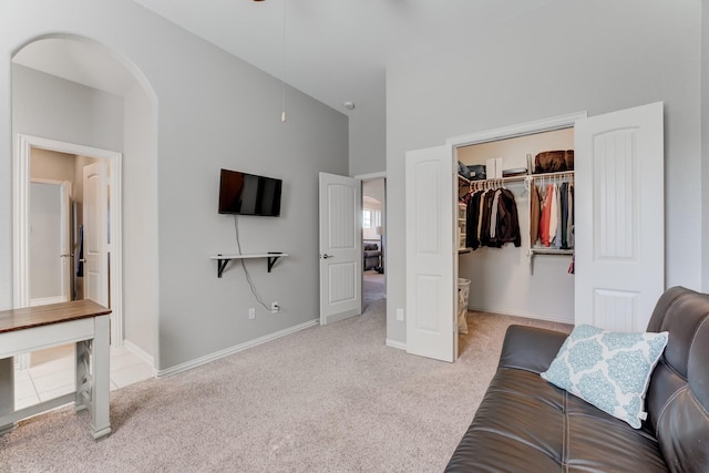 interior space with high vaulted ceiling, arched walkways, baseboards, and carpet floors