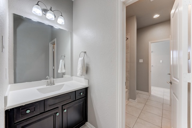 full bath featuring tile patterned floors, vanity, and baseboards
