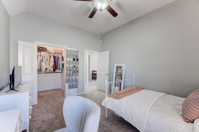 bedroom with a spacious closet, high vaulted ceiling, ceiling fan, and light carpet