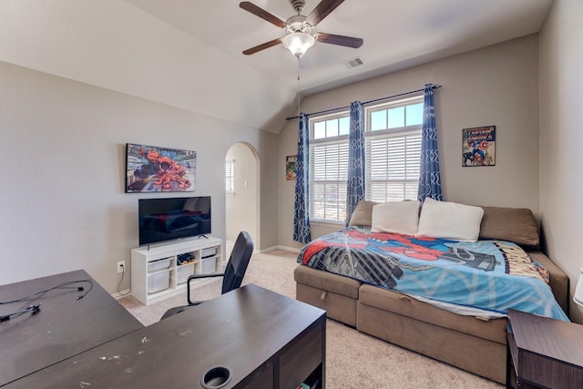 bedroom featuring arched walkways, a ceiling fan, vaulted ceiling, light carpet, and baseboards