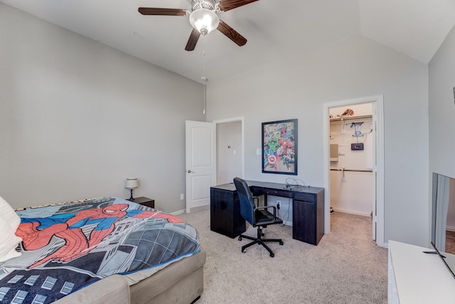 bedroom with baseboards, a spacious closet, ceiling fan, vaulted ceiling, and light carpet