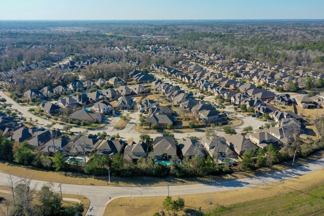 birds eye view of property with a residential view and a view of trees