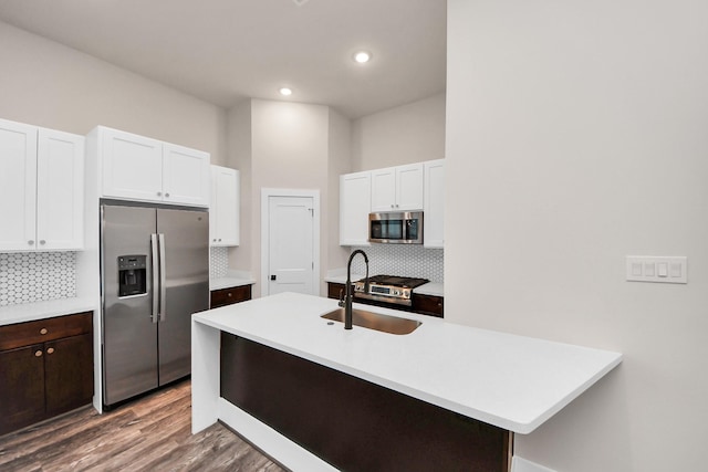 kitchen with light countertops, decorative backsplash, and appliances with stainless steel finishes