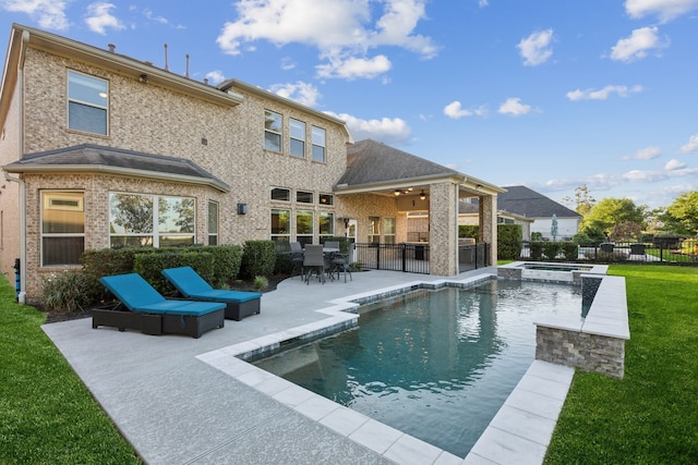 8227 Caroline Ridge Dr, Humble, TX 77396 - back of house with a patio, a ceiling fan, brick siding, a pool with connected hot tub, and outdoor dining space