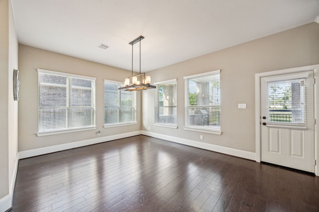 8227 Caroline Ridge Dr, Humble, TX 77396 - unfurnished dining area featuring plenty of natural light, a chandelier, baseboards, and dark wood-style flooring
